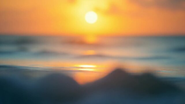Abstract sea summer ocean sunset nature background. Small waves on golden water surface in motion blur with golden bokeh lights from sun. Holiday, vacation and recreation. Weather and climate change