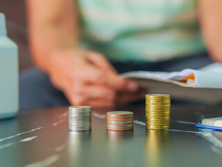 Close-up senior woman hand taking notes income and expenses. Retirement planning to save money. Saving earnings in a piggy bank. Lifestyle people concept retired life, financial or account economy 