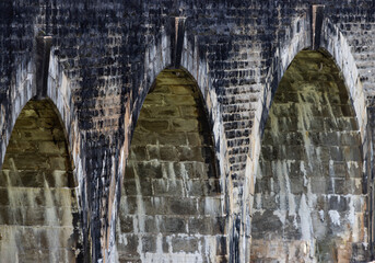Three arches of a stone bridge