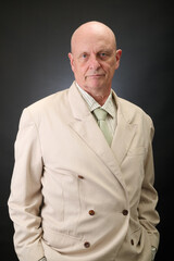 Closeup portrait of a serene aged man in suit