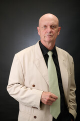 Closeup portrait of a serene aged man in suit