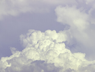 A cloudy sky with a few white clouds