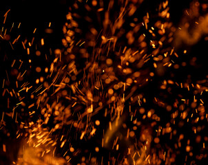 A black background with a lot of orange sparks