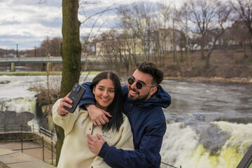 Romantic Hispanic couple taking selfie at Paterson Great Falls