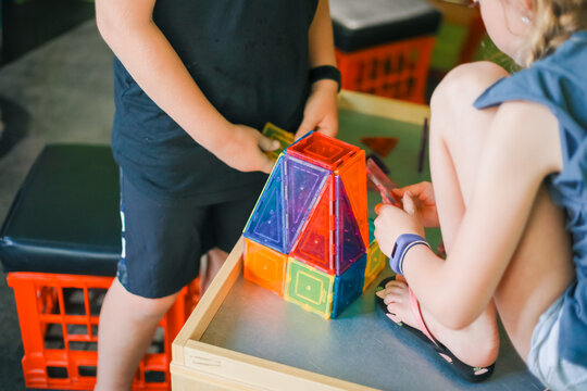 Kids building structure with magnetic block toys