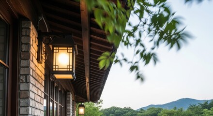 Traditional asian lanterns illuminate rustic wooden architecture with mountain view