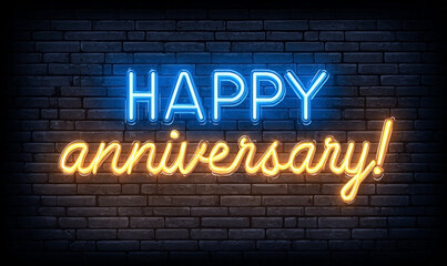 Obraz premium Vibrant Neon Happy Anniversary Message Illuminates Textured Brick Wall.