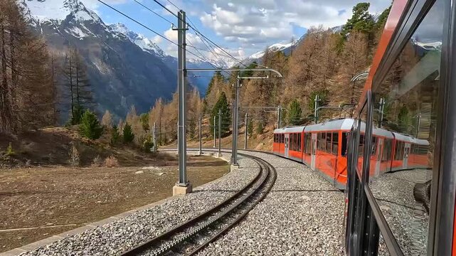 The Gornergrat Bahn train runs downhill towards Zermatt through the Alpine landscape in Zermatt, Switzerland