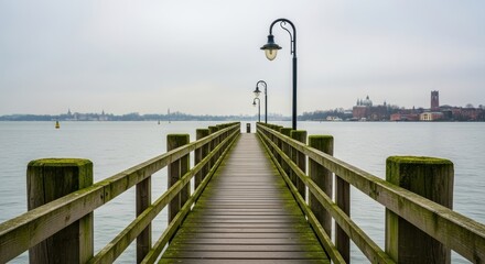 Serene lakeside pier leading to misty city skyline on a cloudy day
