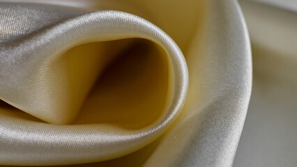 Silky fabric in soft yellow tones draped elegantly
