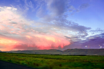 Cloudscape at Dusk in Erzurum Turkey on a cloudy day with green meadows and fields