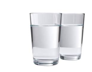Two clear drinking glasses filled with water, side-by-side
