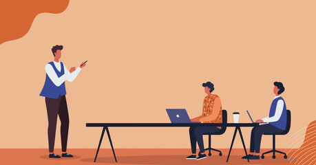 Professional speaker presenting to colleagues working on laptops at a modern table, illustrating business training, team collaboration, and workplace productivity.