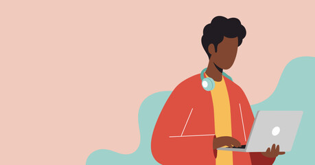 Young Black man with headphones around his neck working on a laptop computer with a minimalist abstract background, representing modern lifestyle and technology.
