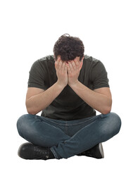 Stressed and depressed man seated on the floor covers face feeling desperate and anxious. Male full length portrait isolated on transparent background
