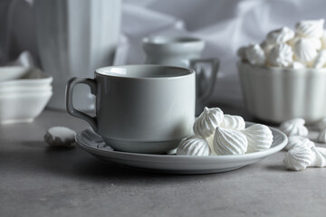 Vanilla meringue and coffee cup on a white marble table.