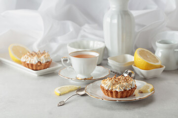 Meringue lemon tart on a white table.