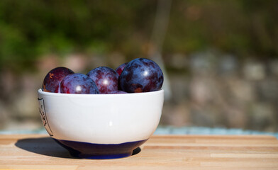plums in a bowl with space for text