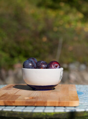 plums in a bowl with text space