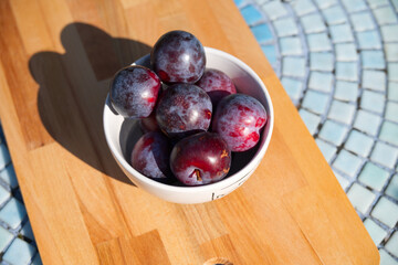 fresh plums in a bowl