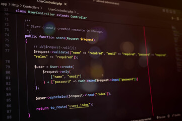 Close-up of PHP Laravel code on a dark editor screen, showcasing user update function and password...