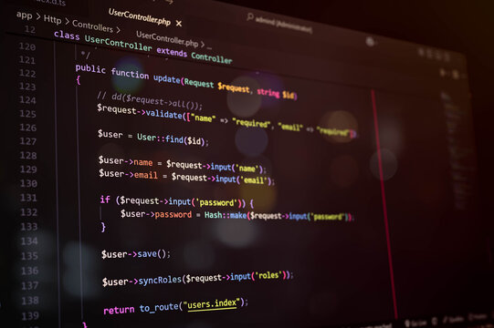 Close-up of PHP Laravel code on a dark editor screen, showcasing user update function and password hashing. Ideal for programming, coding, and web development concepts.