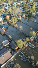 Aerial drone footage showing severe flooding with submerged houses and roads. Wide overhead view of a disaster zone after heavy rainfall, showcasing water damage, extreme weather, and climate-related 