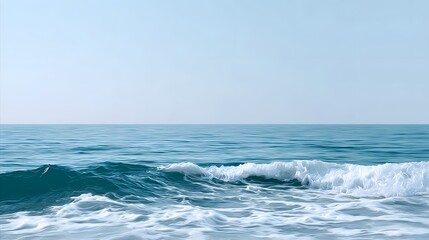 Fototapeta premium A serene seascape with gentle ocean waves rolling across the tranquil water, stretching towards the distant horizon under a clear, azure sky.