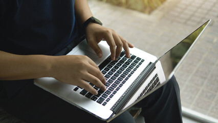 Working on a laptop, sending emails and writing work, and managing important documents.