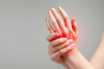 close up of woman hand gently holding and touching another hand, with focus on wrist area showing signs of discomfort or pain. image conveys sense of tenderness and care