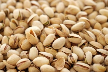 Tasty unpeeled pistachios as background, top view flat lay background