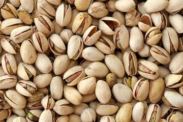 Tasty unpeeled pistachios as background, top view flat lay background