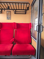 Retro train cabin with empty red seats