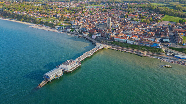 Aerial panoramic drone view of Cromer pier and the coastal town. Turquoise North Sea and the promenade. North Norfolk, England, UK	