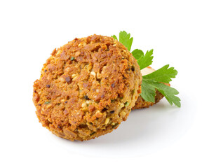 Two golden-brown falafel patties on a white plate, garnished with fresh parsley