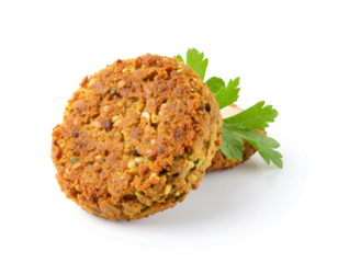 Two golden-brown falafel patties on a white plate, garnished with fresh parsley