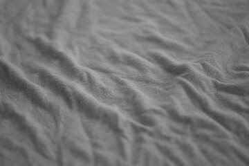 Texture of Dark grey crumpled textile cloth part with small folds