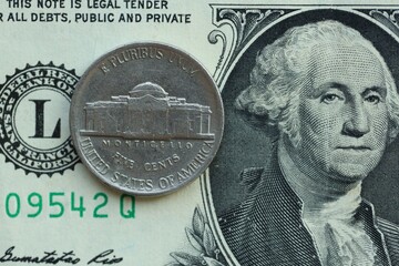 American cent coin on dollar bill close up. United States currency