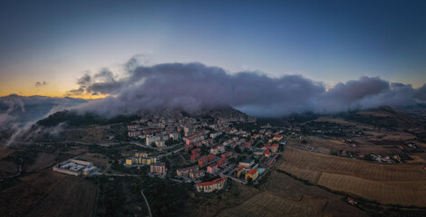 Sunrise view of the rooftops of Gangi with morning fog. Sicily, Italy. August 2024. Aerial drone picture.