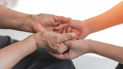Parkinson disease patient, Alzheimer elderly senior, Arthritis person's hand in support of nursing family caregiver care for disability awareness day, National care givers month, aging society concept