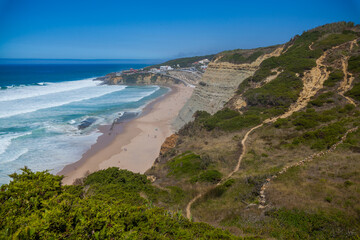 A sweeping coastal panorama featuring a sandy beach