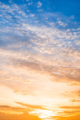 Fototapeta premium Beautiful , luxury soft gradient orange gold clouds and sunlight on the blue sky perfect for the background, take in evening,Twilight, Large size, high definition landscape photo,Vertical