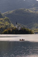 Scenic view of St. Martin's Church in Bled, Slovenia, with its tall spire rising above trees and...