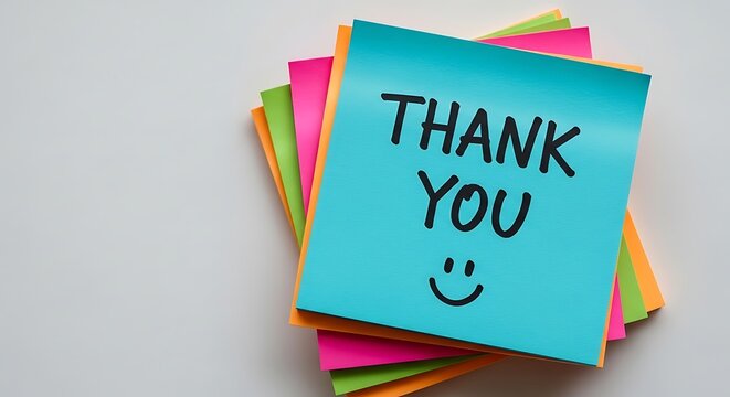 Stack of Colorful Sticky Notes with a Smiling Face Underneath Thank You Message Expressing Gratitude on a Grey