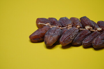Ripe dates isolated on a yellow background