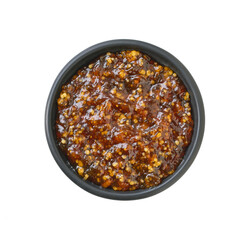 figs jam in a black bowl isolated on white background. Top view.