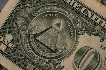 Intricate details of a one dollar bill showcasing the pyramid and eye symbol captured in close-up during daylight hours