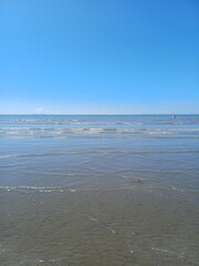 Minimalist Seascape with Gentle Waves and Clear Blue Sky Horizon