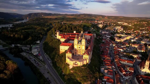 Melk Abbey one of the biggest and most beautiful European Baroque moasteries. Baroqque architecture in Wachau valley in Danube river. UNESCO World Heritage Site .aerial drone footage over sunset