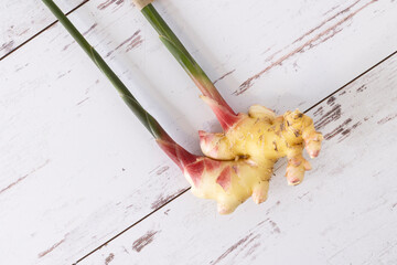 Fresh ginger from farmers market with stems intact.